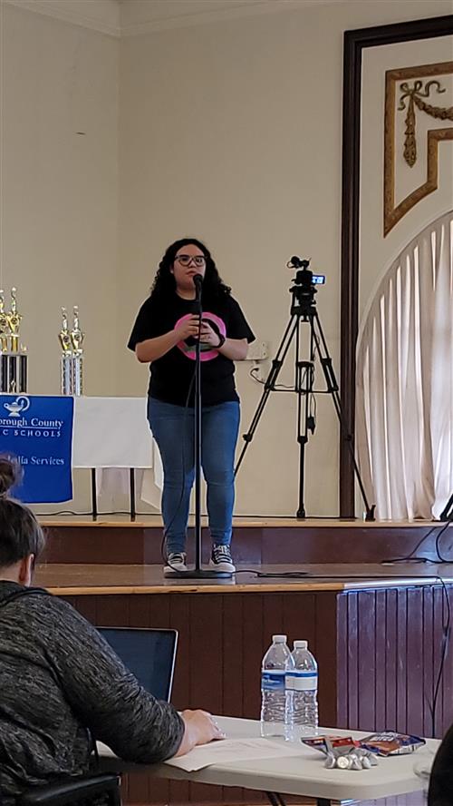 A. Vega performing her poem at the District Poetry Jam